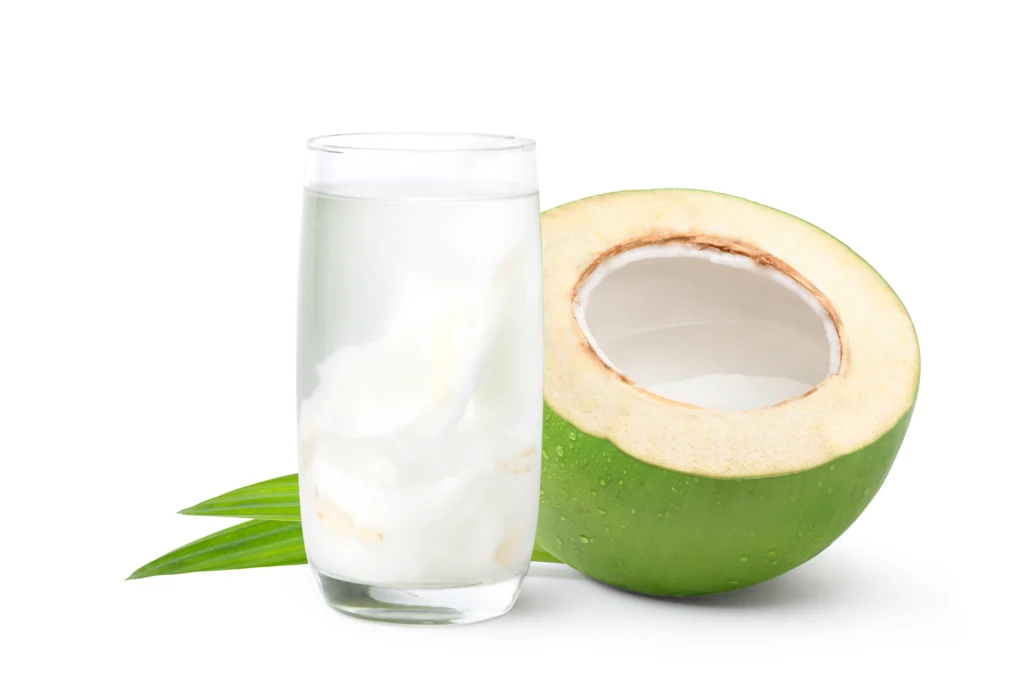 A glass of coconut water and a fresh coconut