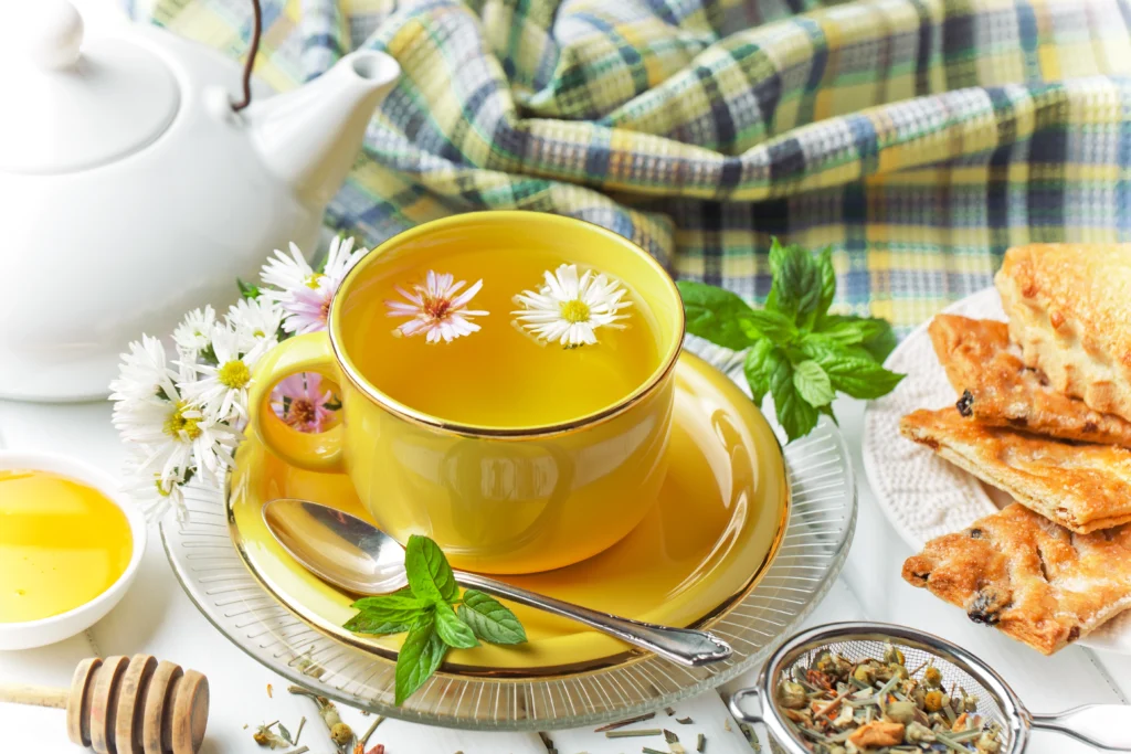 A cup of green tea with green tea leaves