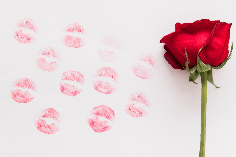 Fresh flower and lipstick kiss on paper